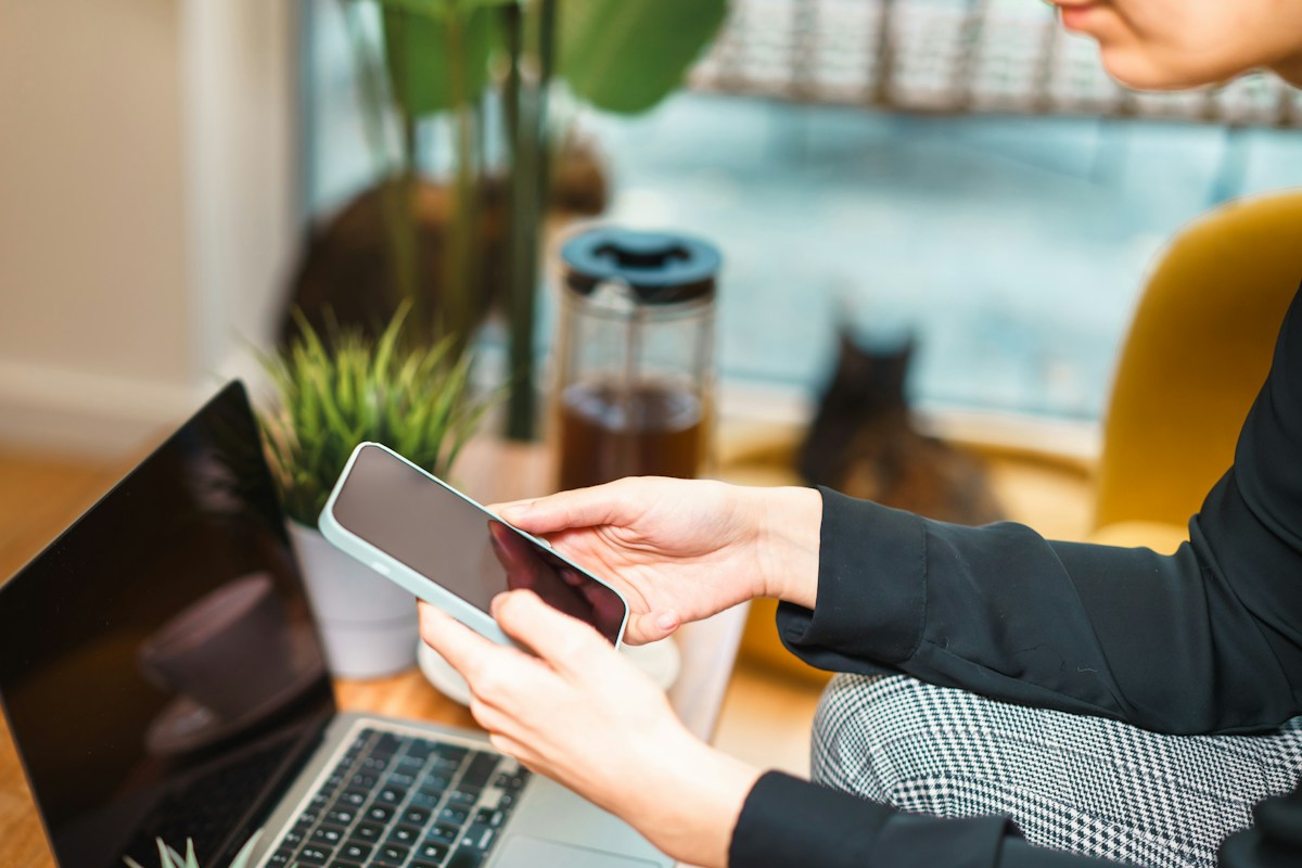 Un e-mail consulté sur un téléphone, à côté de l'ordinateur
